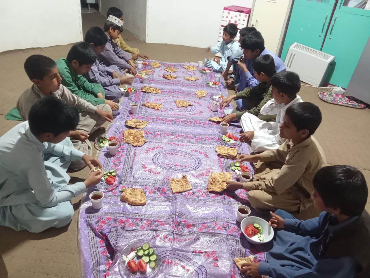 دانش آموزان سفینة النجاه در یکی از روستاهای استان سیستان و بلوچستان در حال افطار